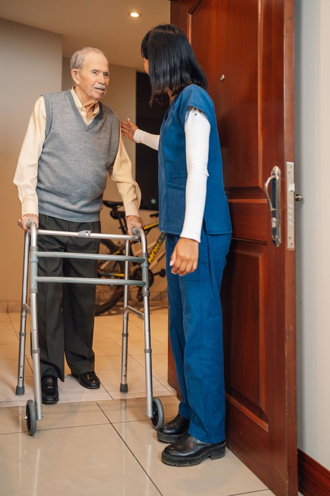 senior with nurse entering room